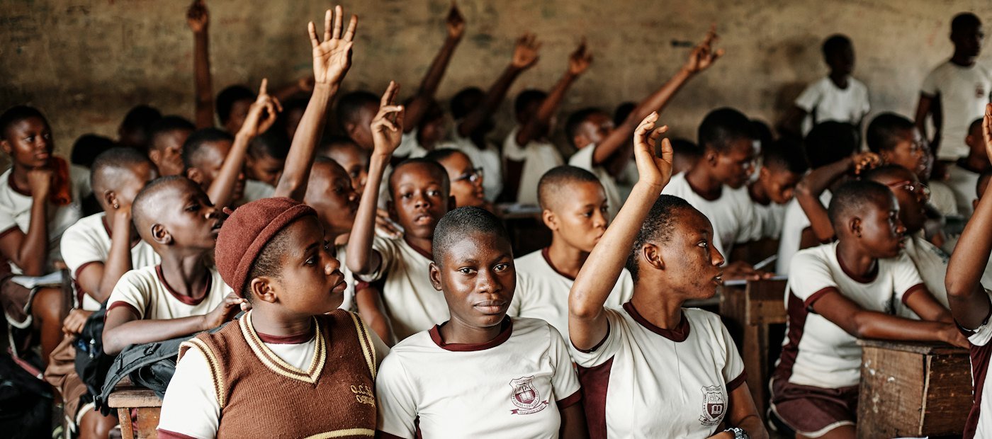 Pupils raising their hands in class